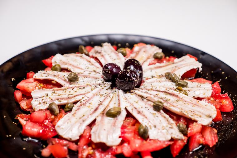 Marinated anchovies with tomato