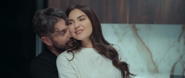 Couple embracing in a marble kitchen
